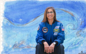 Nicole Stott in front of wave paint